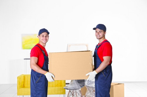 Business team preparing office removals in Acton with packed boxes and desks