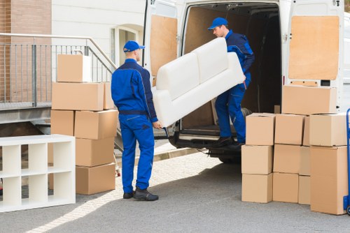 Professional Acton movers handling packed boxes with care