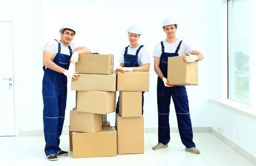 Professional movers handling furniture during a house removal in Acton