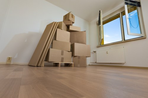 Packed boxes and furniture ready for a house move in Acton