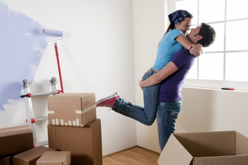 Loading furniture into a moving van on an Acton street