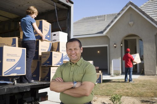 Organized movers preparing items for transport in Acton
