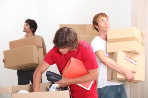 Packed boxes and moving equipment for local removals in Acton
