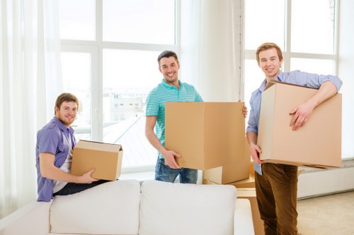 Professional movers transporting office furniture during a relocation in Acton