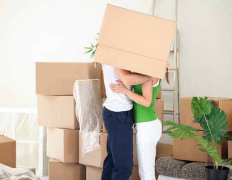 Professional movers packing and loading household items in Acton