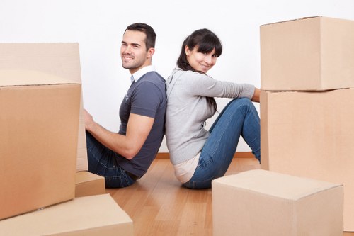 Professional movers carrying furniture during an Acton relocation