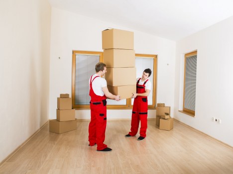 Local Acton removals team carrying furniture for a same day move
