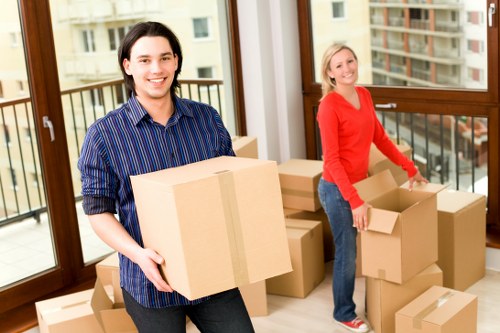 Professional movers packing boxes for an Acton relocation